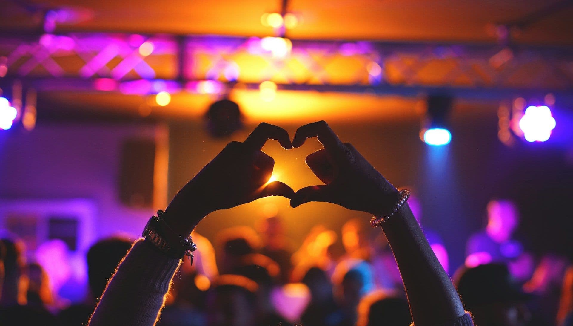 Heart hand sign at a concert